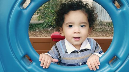 Portrait of happy boy playing in car