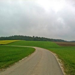 Country road passing through field