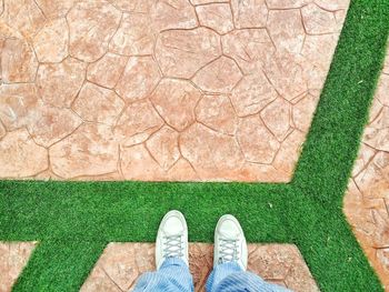 Low section of man standing on footpath