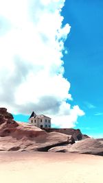 House on desert against sky