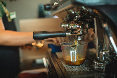 Close-up of hand pouring wine in glass