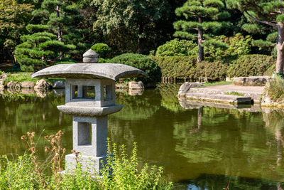 Built structure in garden by lake