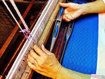 Close-up of person hand working at textile industry