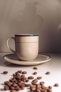 A cup with a saucer and a few coffee beans. retro, vintage style