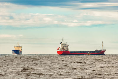 Ship sailing in sea against sky