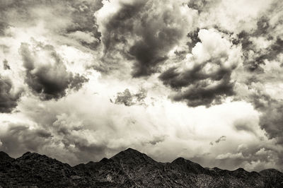 Scenic view of mountains against cloudy sky