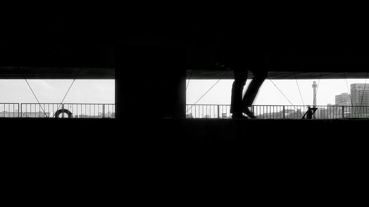 silhouette, lifestyles, walking, full length, men, standing, person, leisure activity, indoors, dark, built structure, architecture, rear view, railing, shadow, sunlight, side view