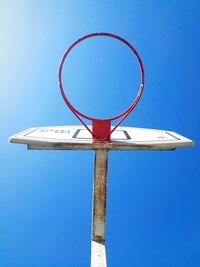 Low angle view of basketball hoop against clear blue sky