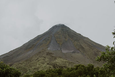 Low angle view of volcanic mountain against sky