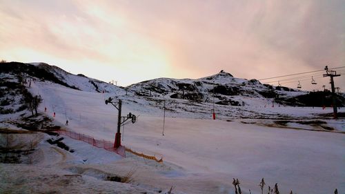 Scenic view of snow on mountain against sky during sunset