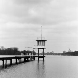 Lifeguard hut by sea against sky