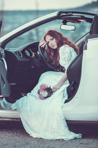 Woman with umbrella in car