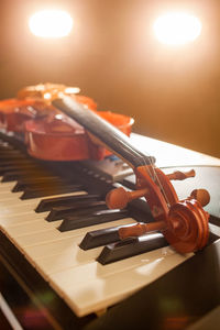 Close-up of violin with piano on table