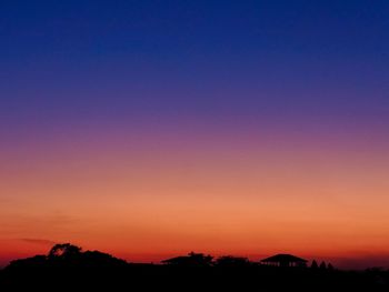 Scenic view of silhouette landscape against clear sky at sunset