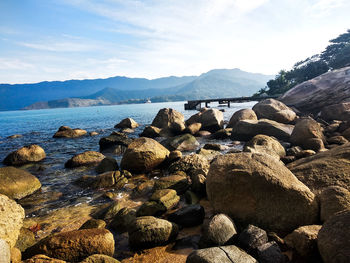 View of rocks on beach against sky