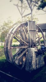 Close-up of wheel against trees