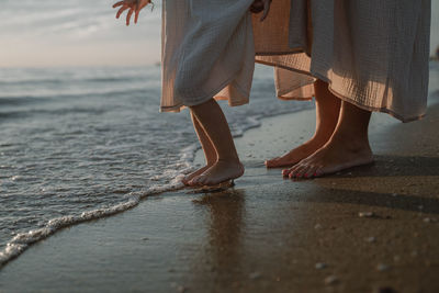 Low section of woman standing on beach