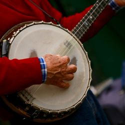 Midsection of man playing banjo