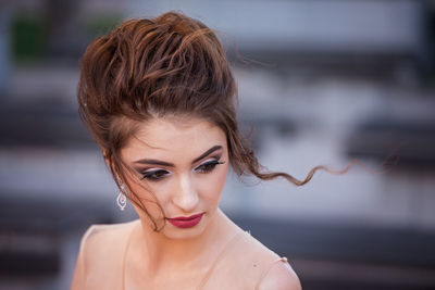 Portrait of woman against blurred background