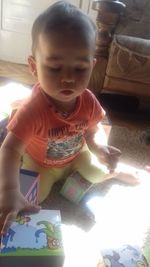 Cute boy playing with toy at home
