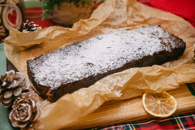 Christmas cake with dried fruit sprinkled with powdered sugar