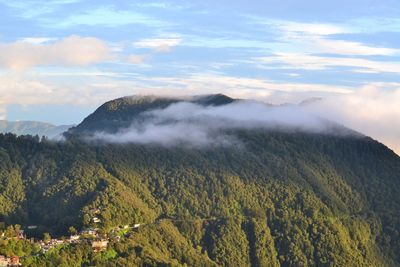 Scenic view of mountain against sky during foggy weather