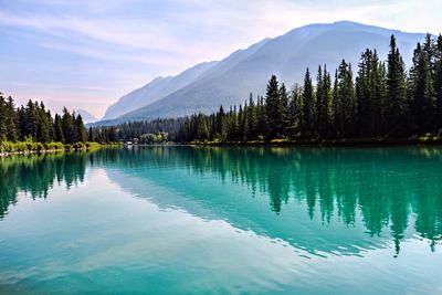 Scenic view of lake and mountains against sky