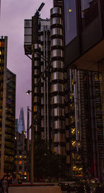 Low angle view of illuminated buildings against sky at night