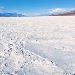 Salt flat with mountain in background