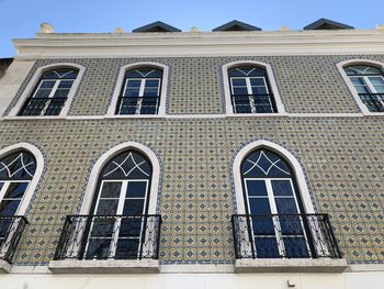 Low angle view of building against blue sky