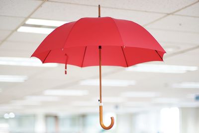 Close-up of red umbrella hanging on ceiling