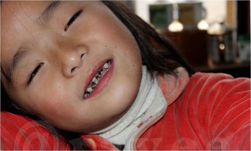 Close-up of cute girl sleeping on sofa at home