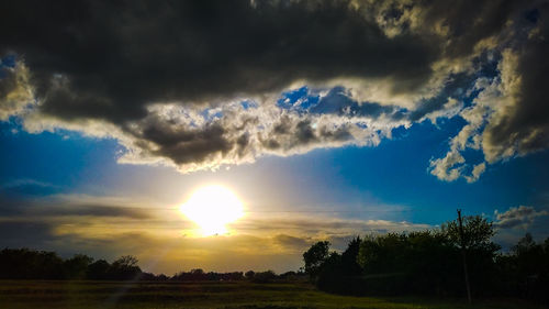 Scenic view of field against sky during sunset