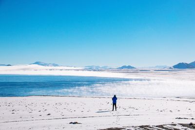 Full length of man on beach against clear sky