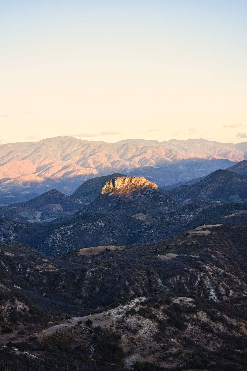 HIGH ANGLE VIEW OF MOUNTAINS AGAINST SKY DURING SUNSET