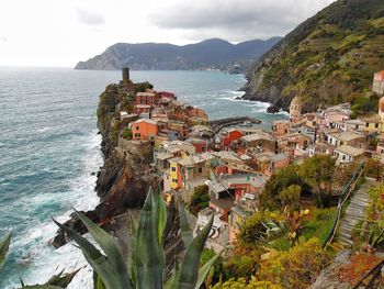 Scenic view of sea and mountains against sky