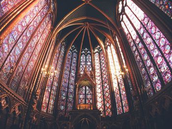 Low angle view of stained glass windows in church