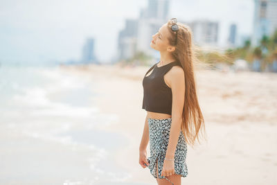 Young woman standing at beach