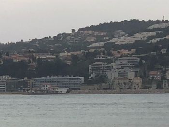 Buildings in city against clear sky