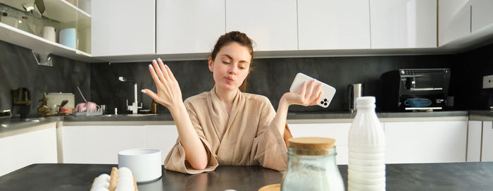 Portrait of woman preparing food in kitchen