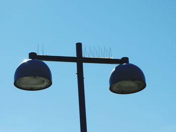 Low angle view of street light against clear blue sky