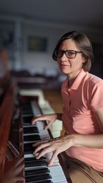 Portrait of young woman playing piano