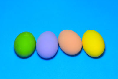 Close-up of multi colored candies against blue background