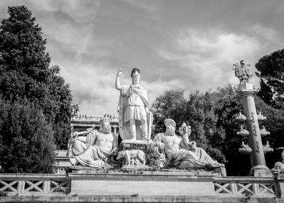 Low angle view of statue against cloudy sky