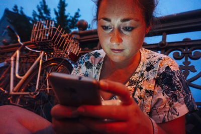 Close-up of young woman using mobile phone