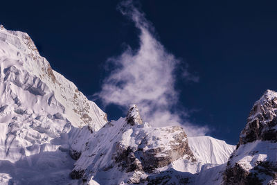 Scenic view of snow covered mountains against sky