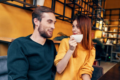 Young couple in drinking glass