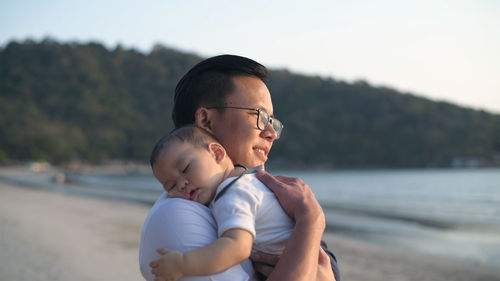 Father and son holding water