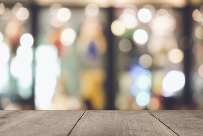 Defocused image of illuminated lights on table