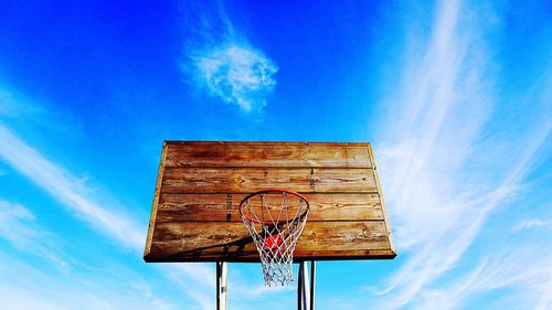 Low angle view of basketball hoop against blue sky